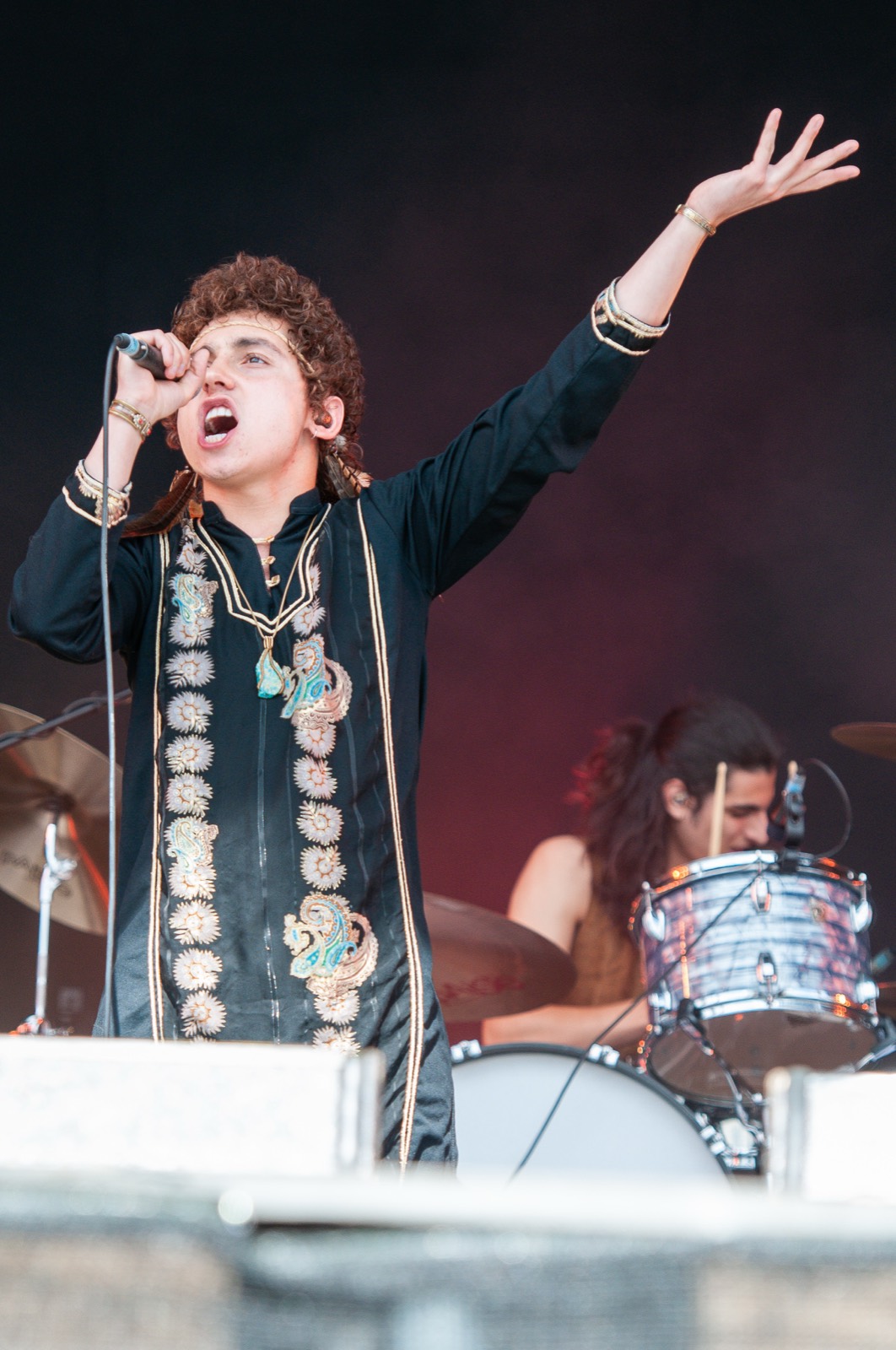 Josh Kiszka, arm raised, in moody stage light