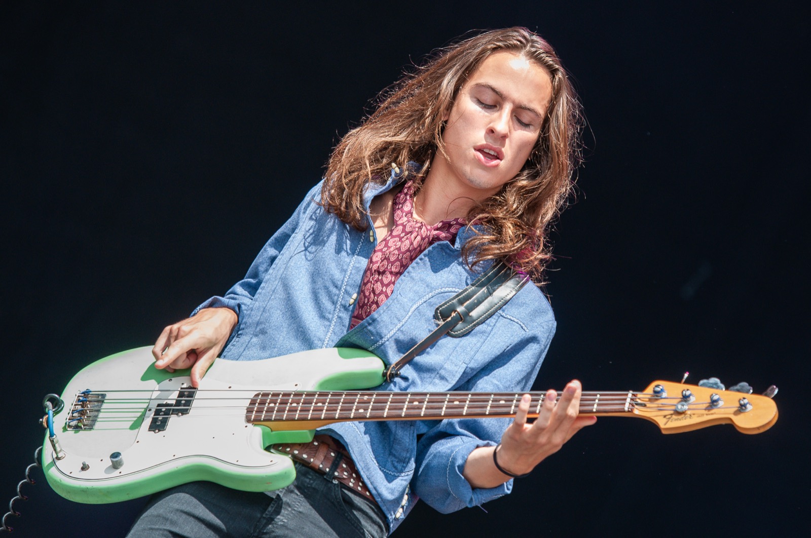 Sam Kiszka on bass, framed in black