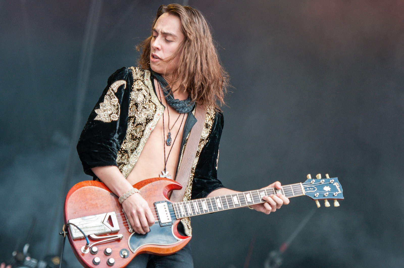 Jake Kiszka playing guitar in stage smoke