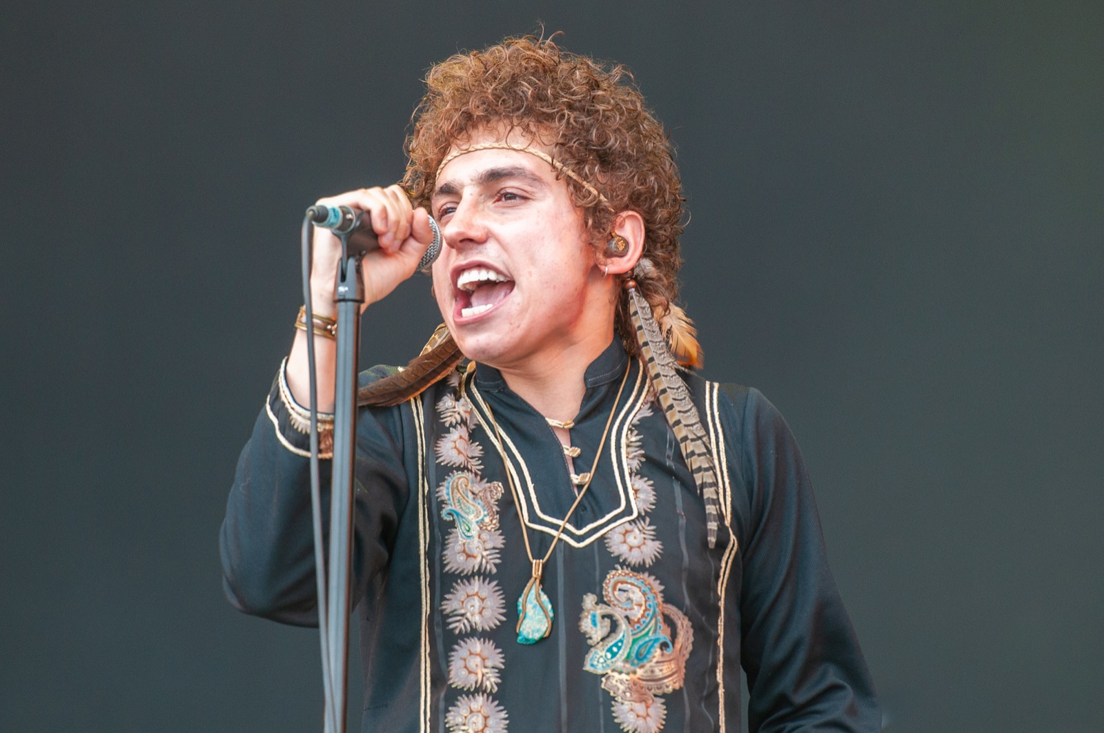 Josh Kiszka mid-vocal under the lights