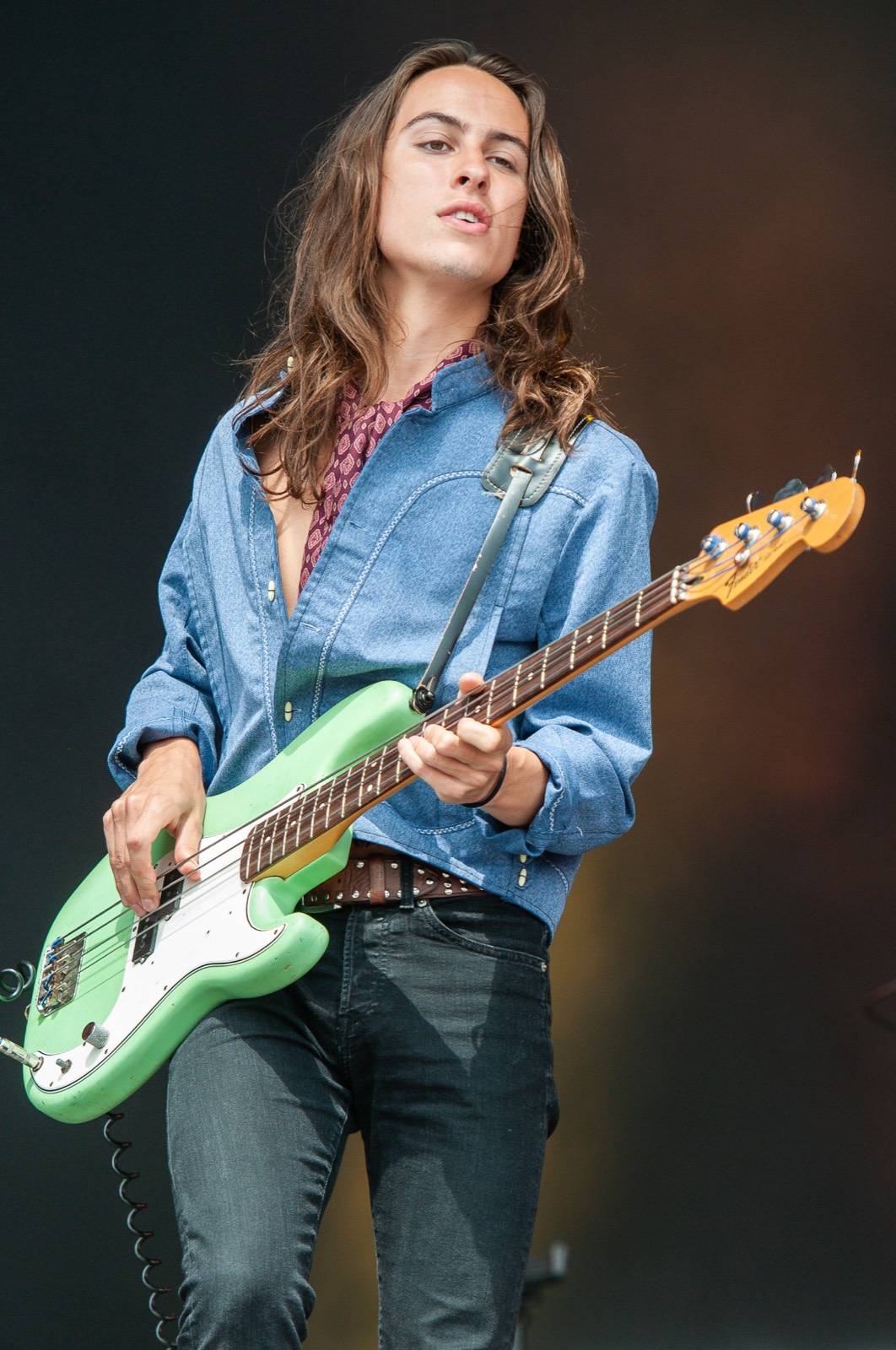 Sam Kiszka on bass in warm, moody portrait light